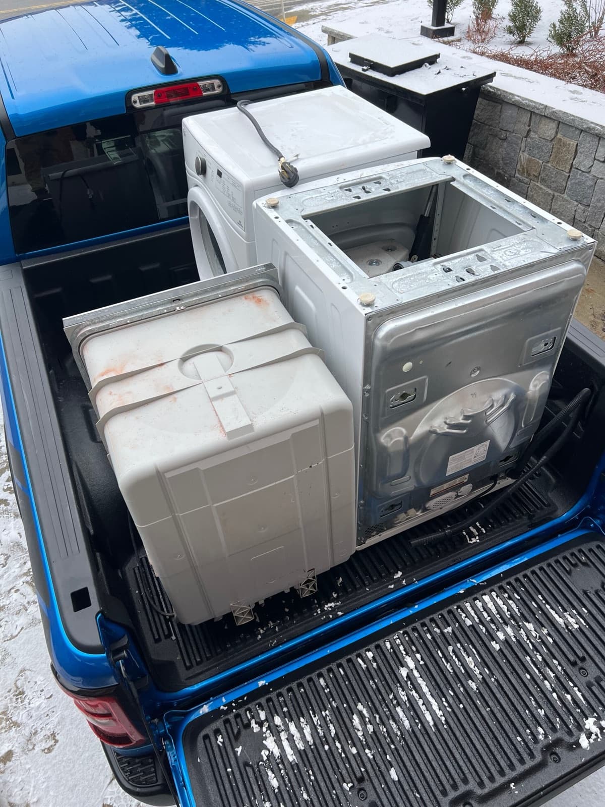 A washer, dryer and dishwasher loaded in the bed of a pickup truck on a Harbor Haul job